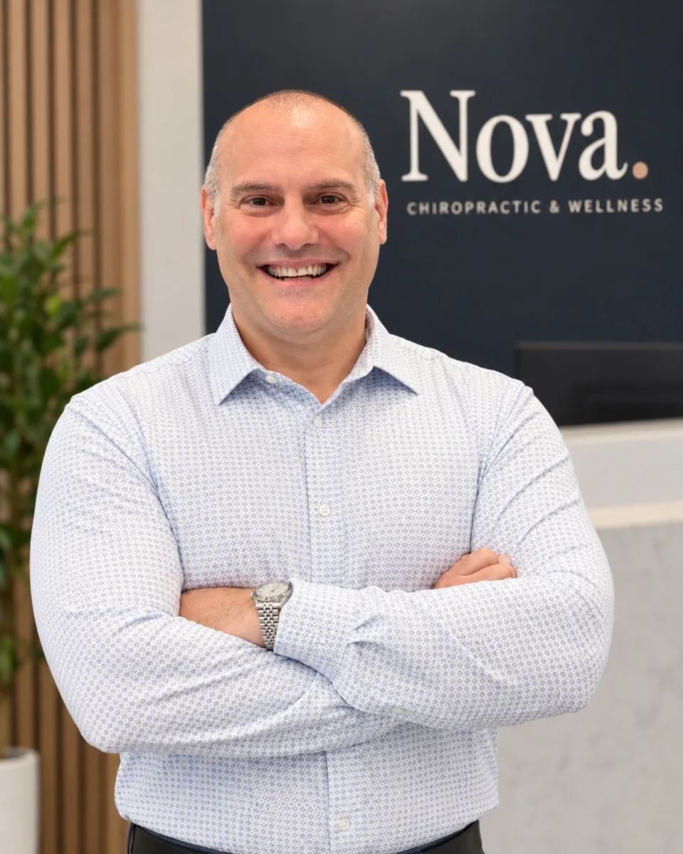 Dr. Dejan Jelic, DC, at the front desk of Nova Chiropractic & Wellness